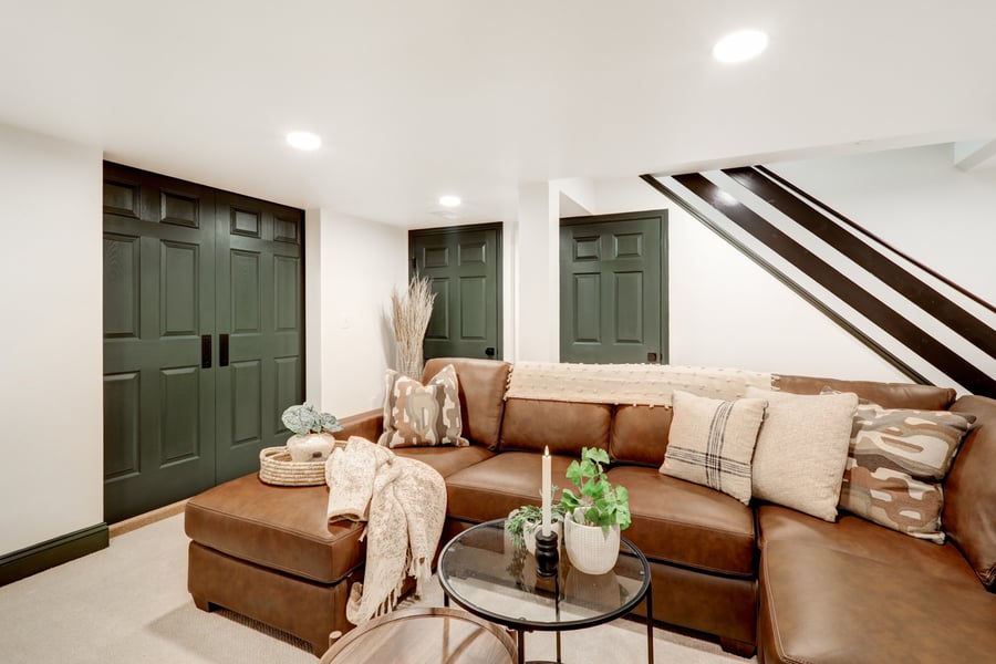 Lancaster Basement remodel with large sectional and green trim