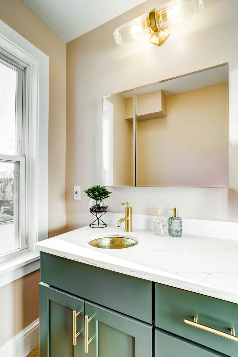 Lancaster Primary Bathroom Remodel with green vanity and gold accents