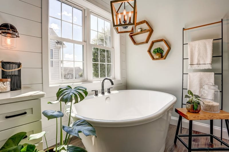 Plants beside freestanding tub in Landisville bathroom remodel