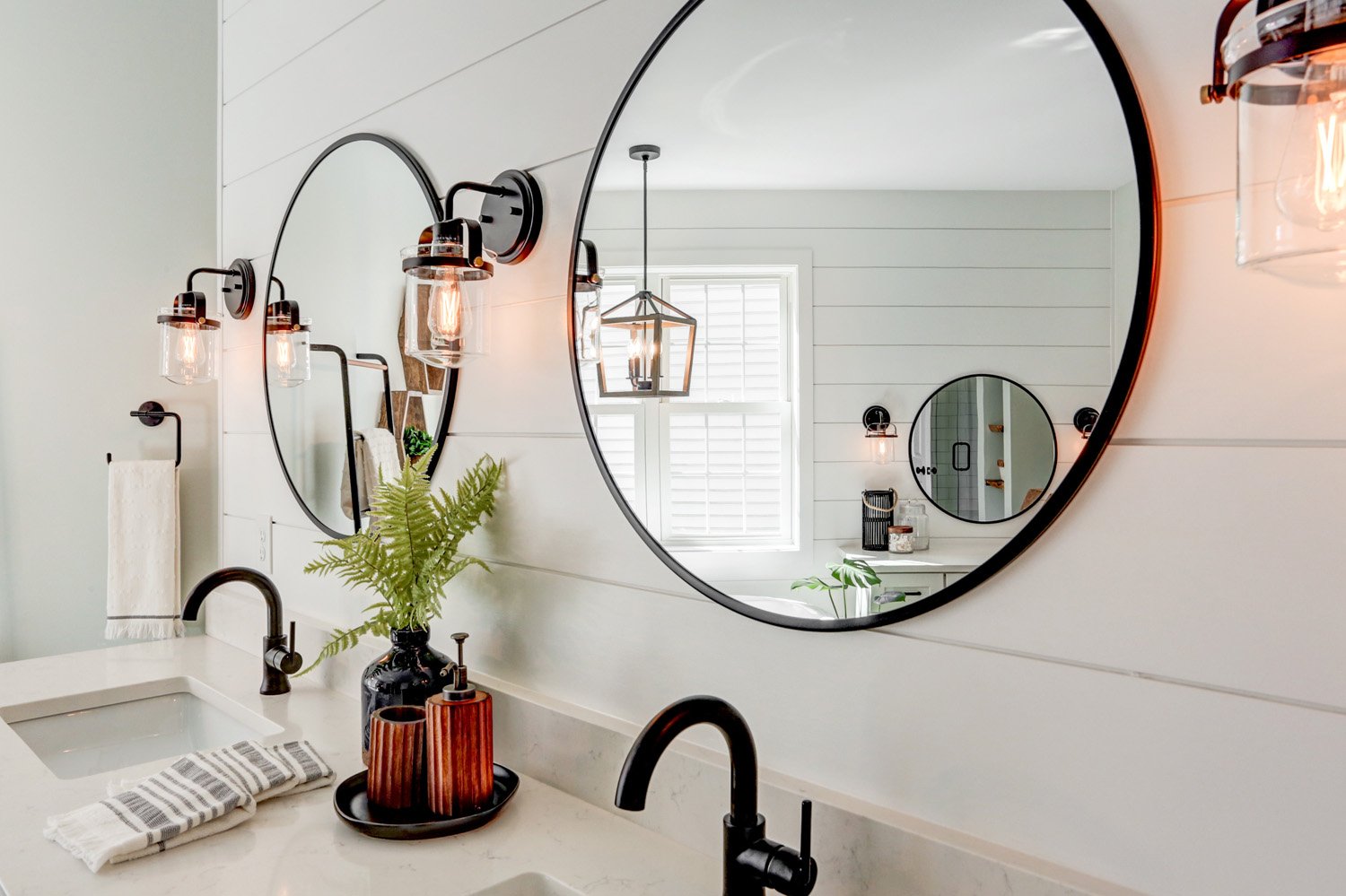 Landisville Primary Bathroom Remodel with matte black circle mirrors
