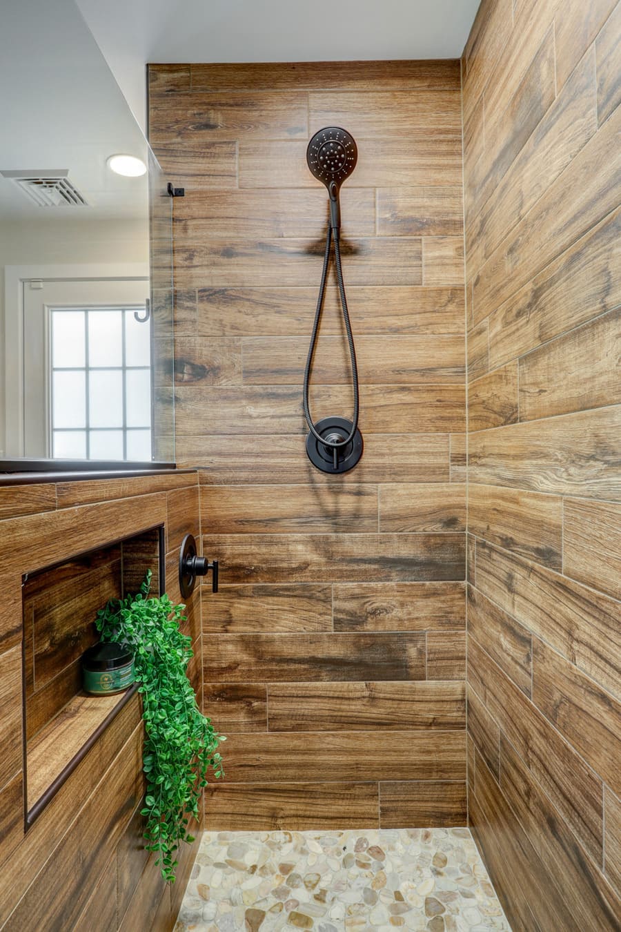 wood shower with pebble floor in Lancaster Bathroom Remodel