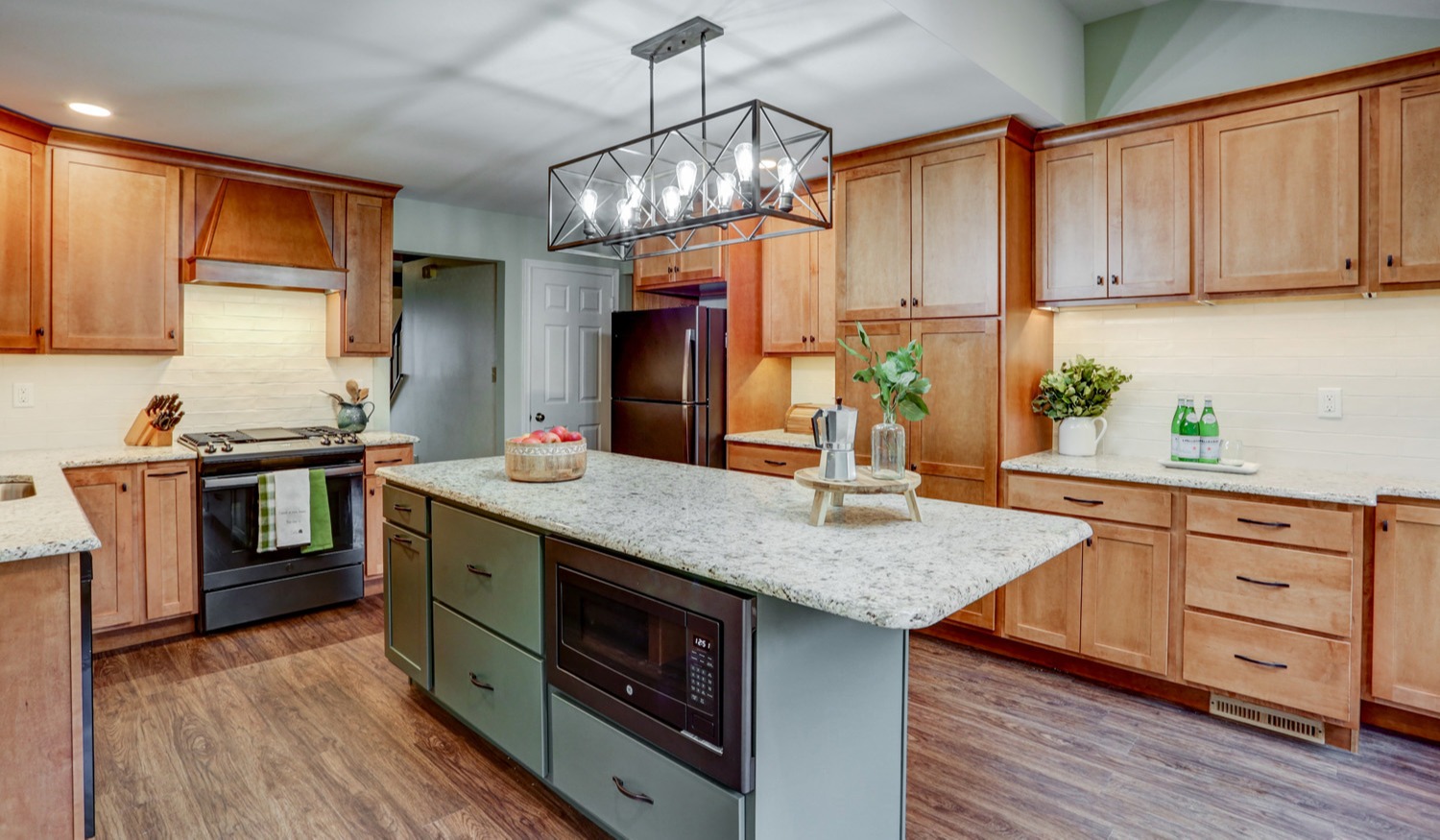 hempfield kitchen remodel with brown cabinets and green island