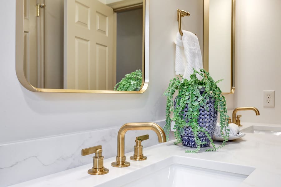 Gold faucet and quartz countertop in Strasburg guest bathroom remodel