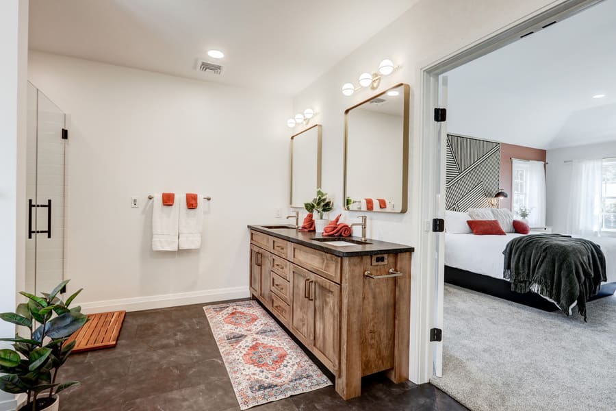 Lancaster Primary Bathroom Addition with double vanity and black floor