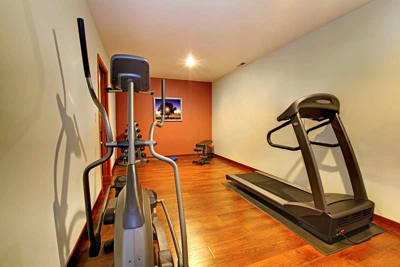 home gym equipment in a finished basement
