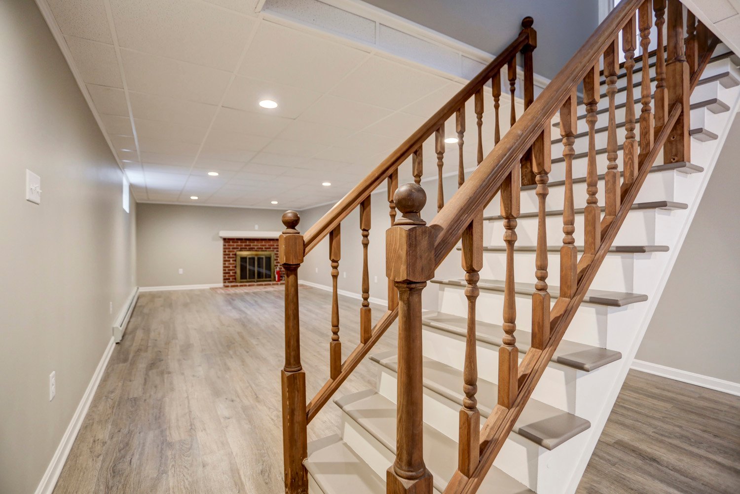 Dark wood Railing on newly finished stairs in Millersville Basement Remodel