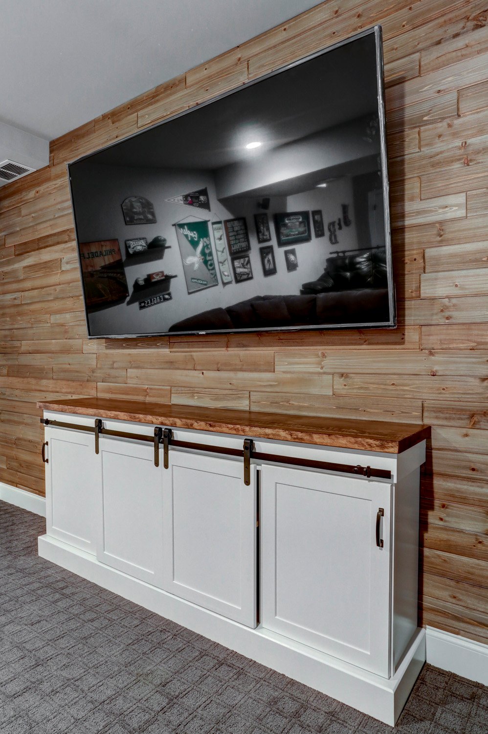 Accent wall and white storage space in Lititz Basement Remodel