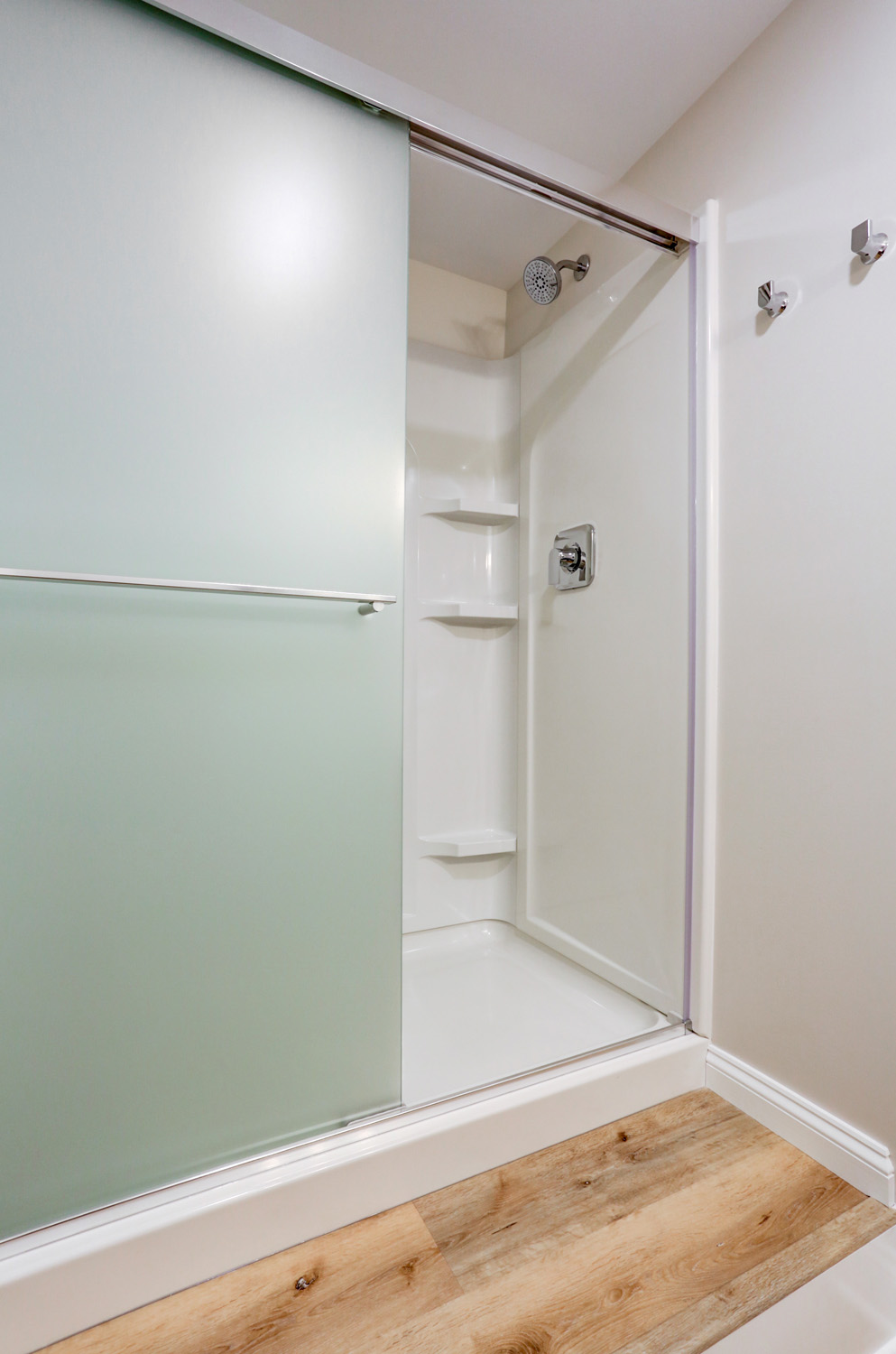 Basement bathroom addition with shower and sliding doors in Lampeter