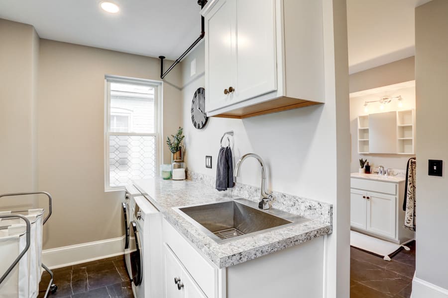 Master bathroom with adjacent laundry room