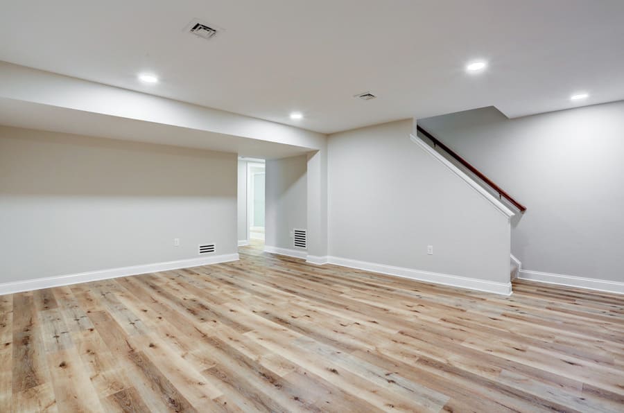 Basement remodel with open staircase and wood flooring