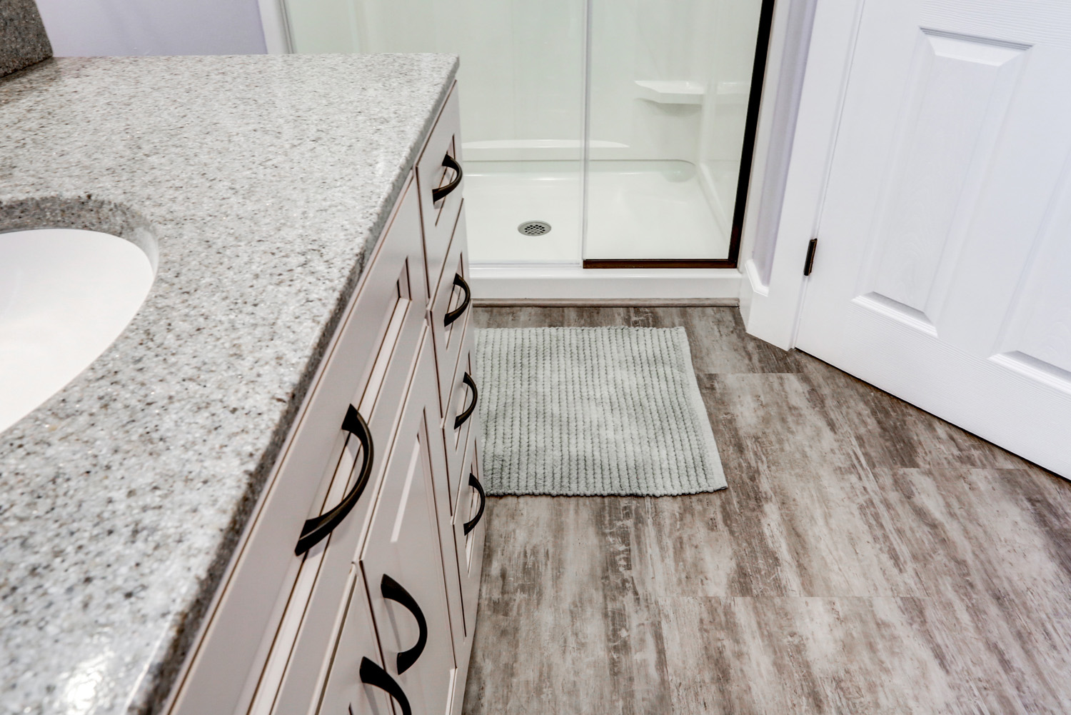 Matte Black hardware and vinyl plank flooring in Millersville bathroom remodel