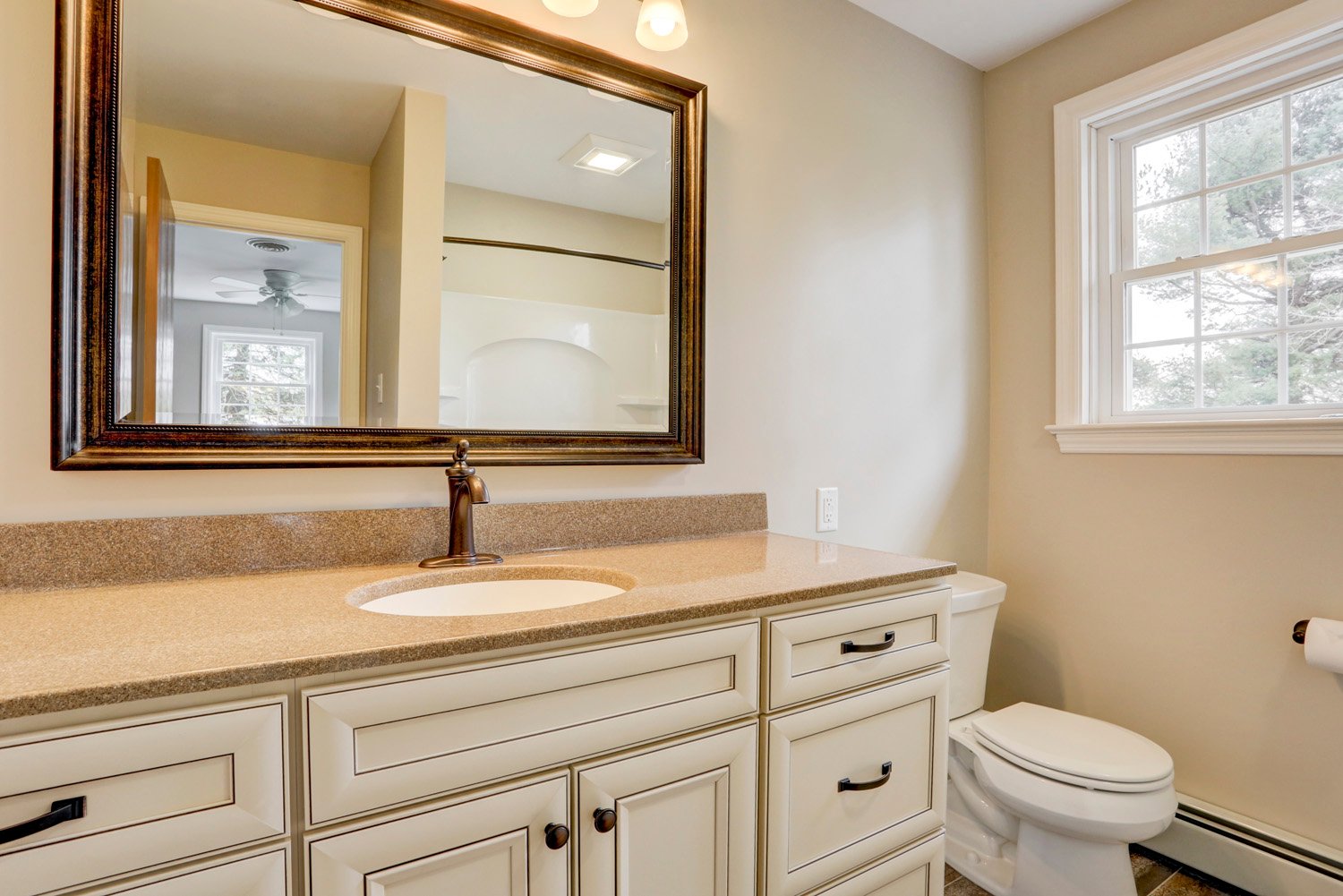 Single sink with white cabinets in Millersville Double Bathroom Remodel