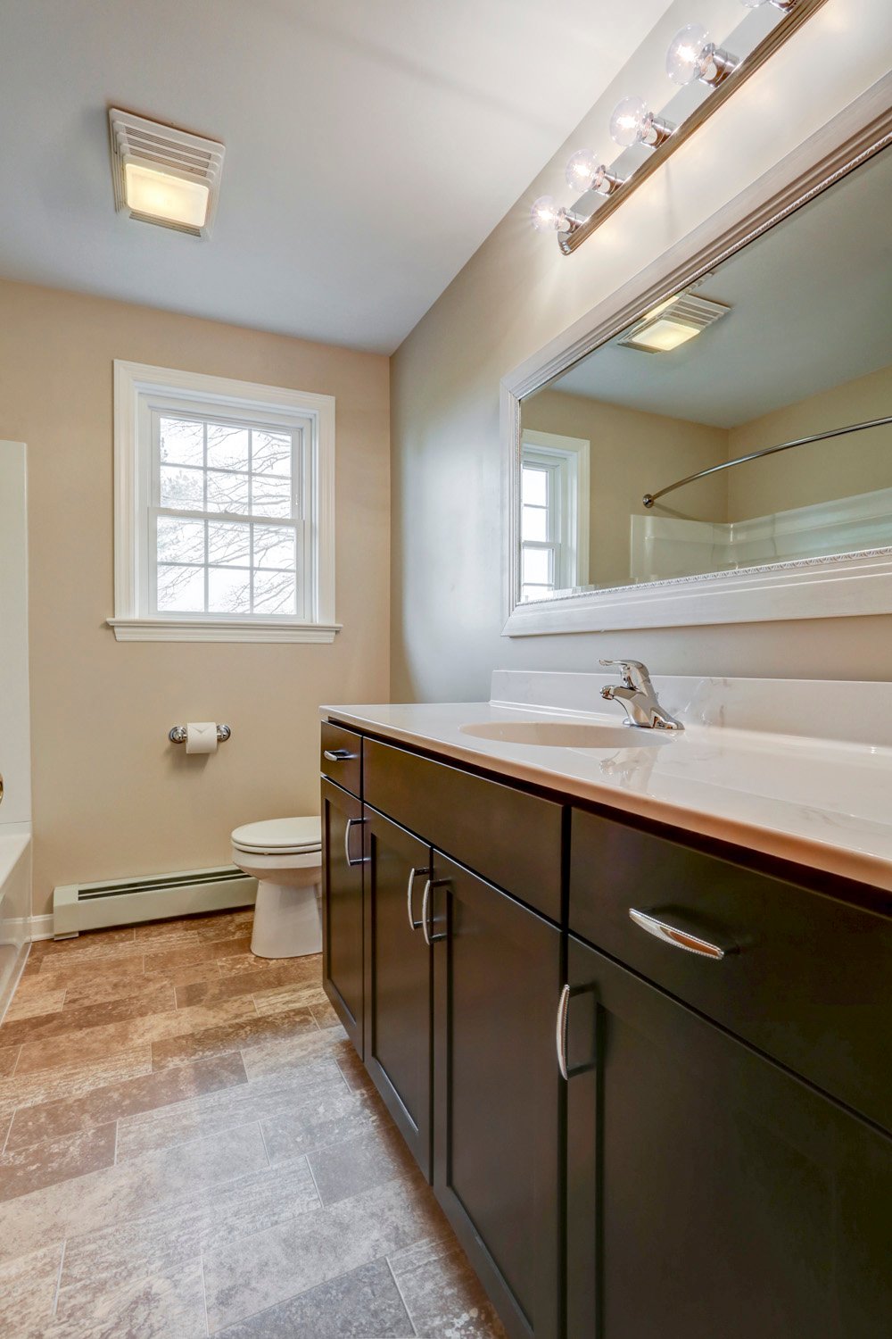 Millersville Double Bathroom Remodel with dark brown vanity