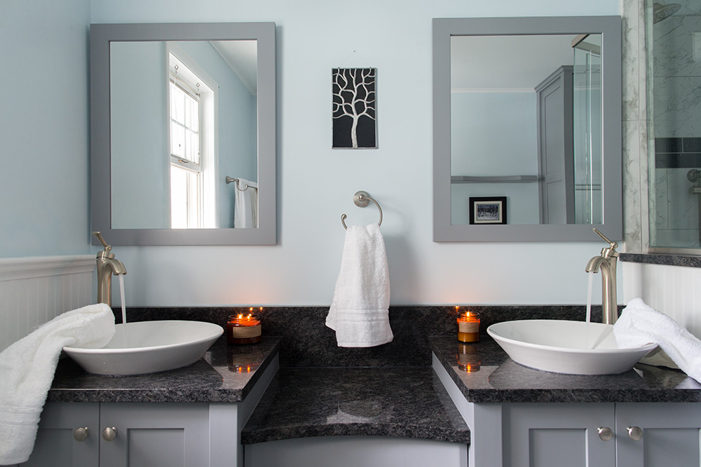 Gray double vanity with black marble top and double vessel sinks in Millersville Master Bathroom Remodel