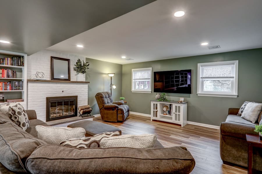 Lititz Basement Remodel with brick fireplace and green walls