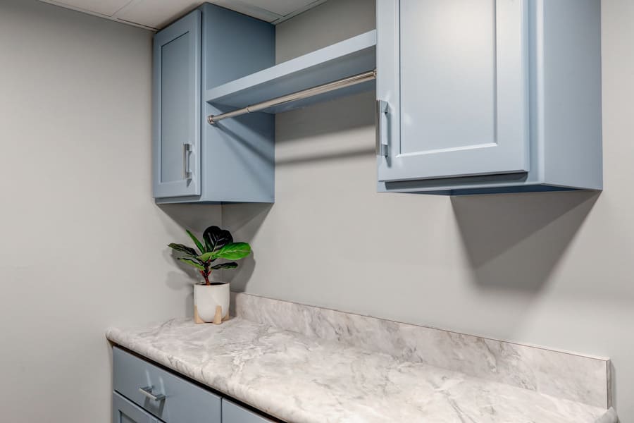 blue cabinets and clothes hanger in Lititz Basement laundry room Remodel