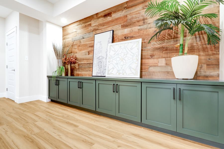 wooden accent wall and green cabinets in Lititz Basement Remodel 