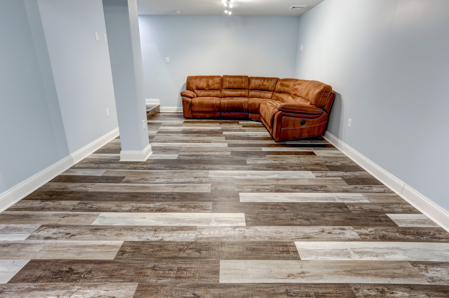 Weathered vinyl plank flooring in Millersville Basement Remodel