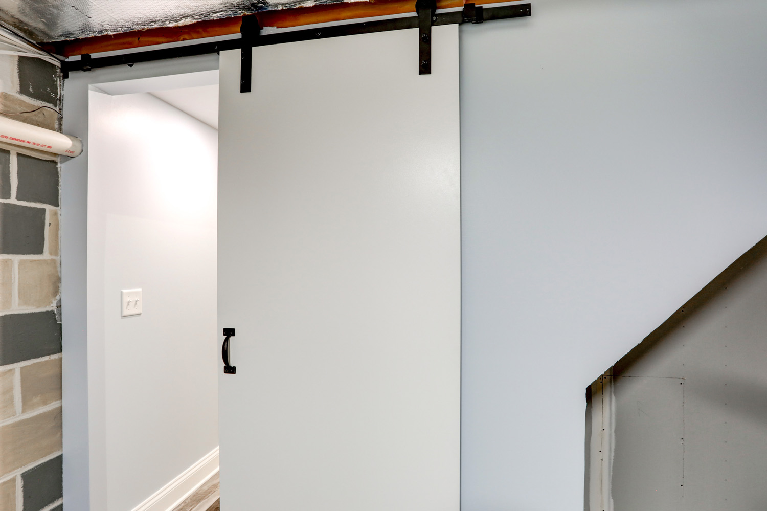 Barn doors in utility room in Millersville Basement Remodel