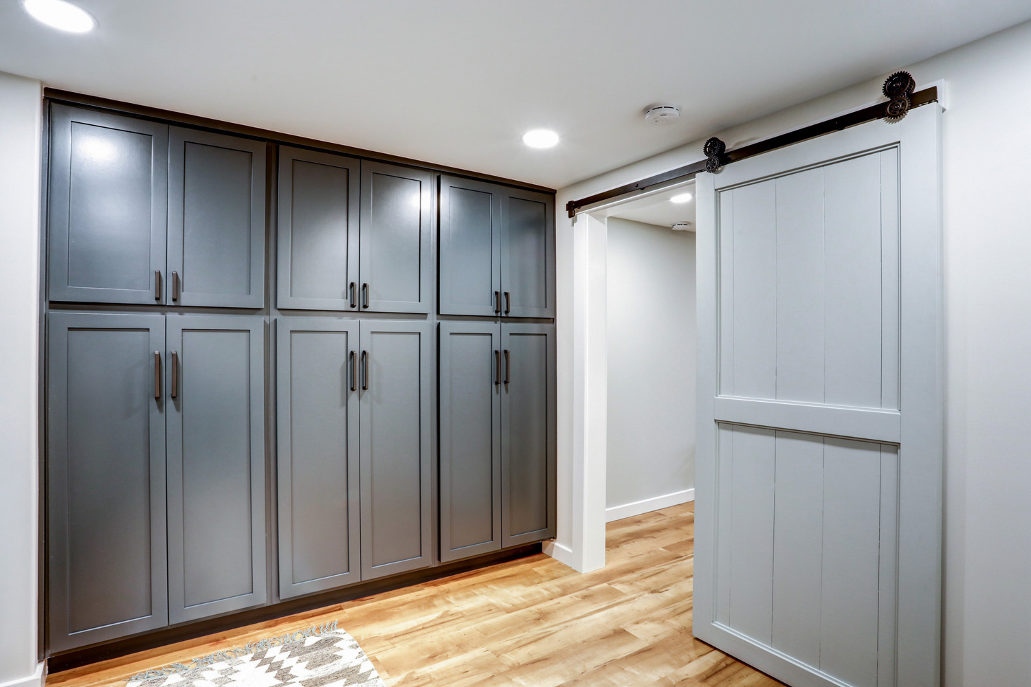 Lancaster Basement Remodel with sliding barn door in laundry room