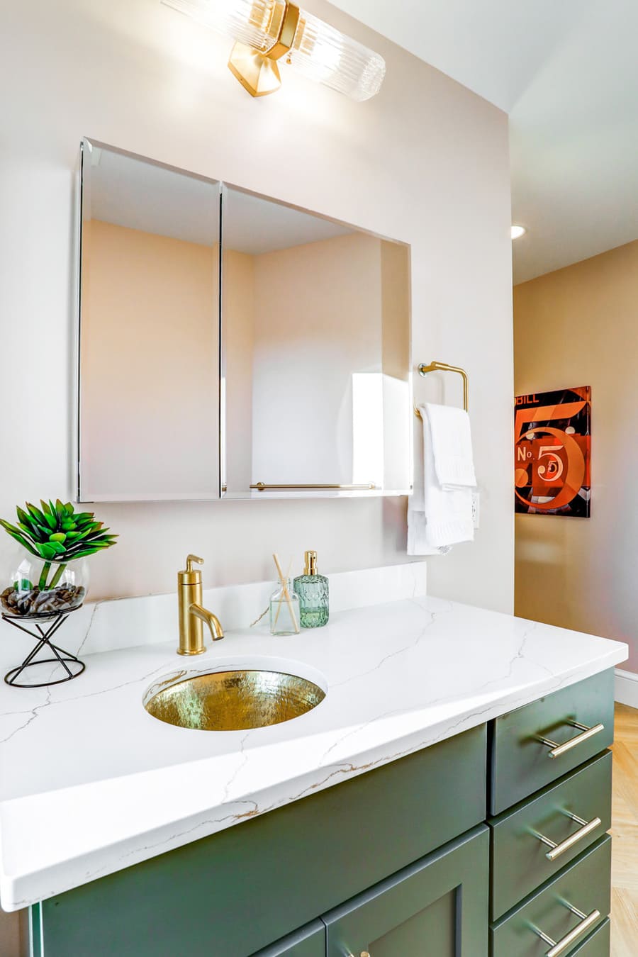 green vanity with gold accents in Lancaster Primary Bathroom Remodel