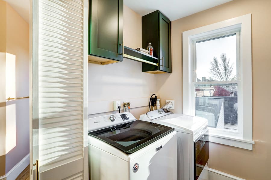 laundry room with green cabinets in Lancaster Primary Bathroom Remodel