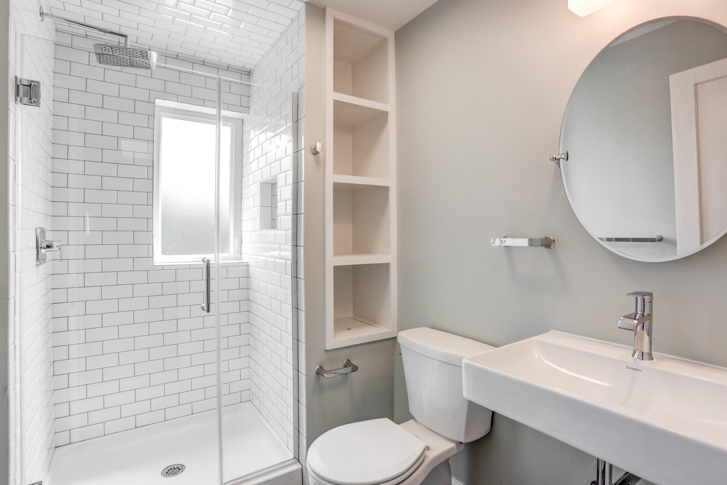 Small Lancaster City bathroom remodel with custom built-in storage and tile shower