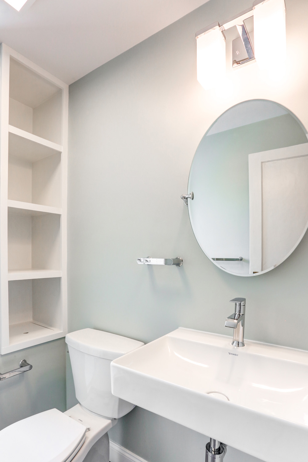 circular mirror and pedestal sink in Lancaster City Bathroom Remodel