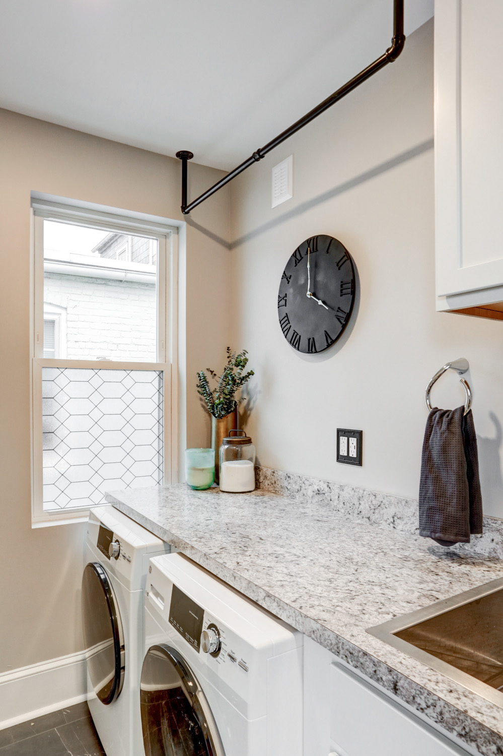 Lancaster Laundry Room Remodel with industrial clothes hanging bar