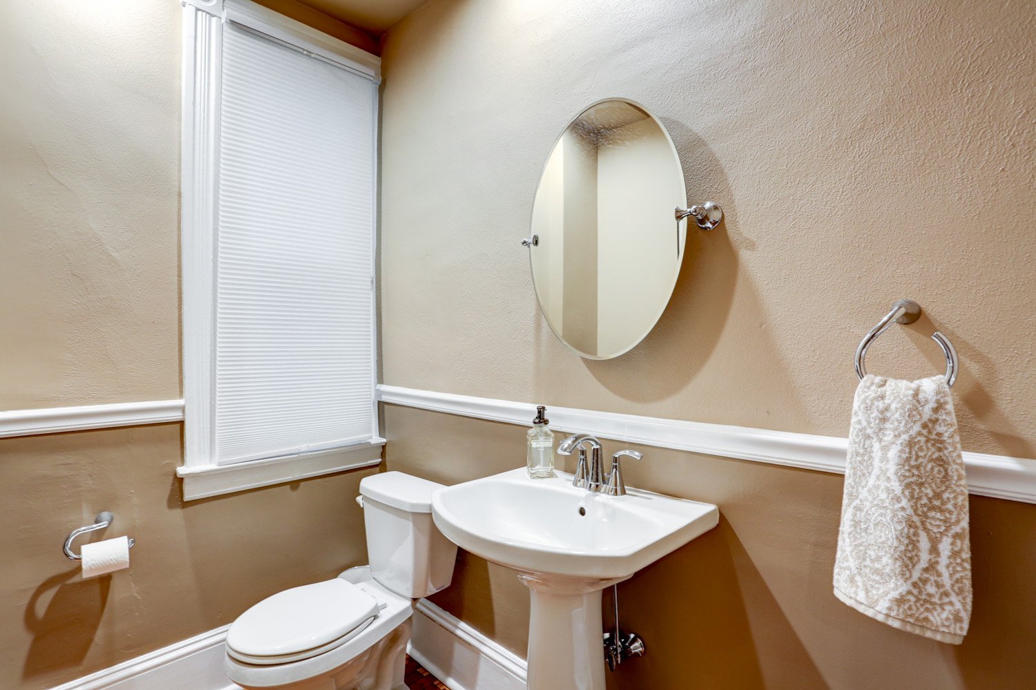 Lancaster Half Bathroom Remodel with pedestal sink and oval mirrot