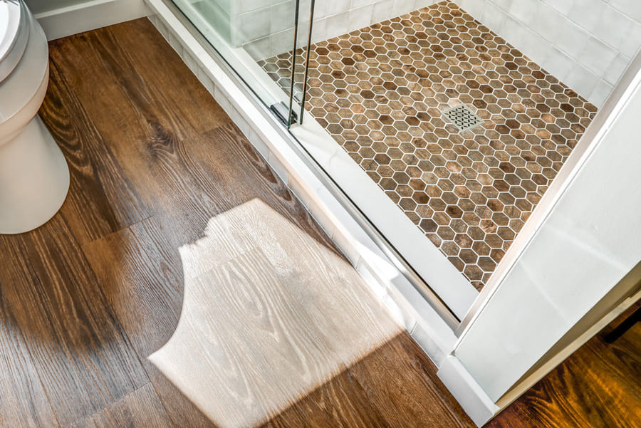 LVP flooring with stone tile on shower floor in Rohrerstown Bathroom Remodel