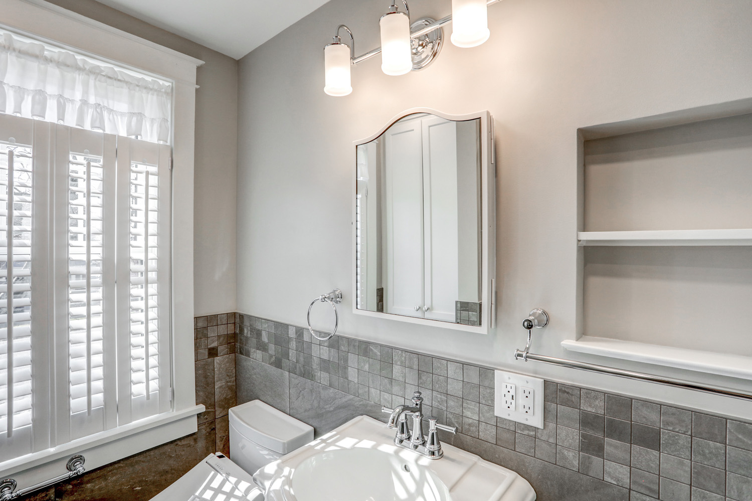 Mirror above pedestal sink in Manheim township bathroom remodel