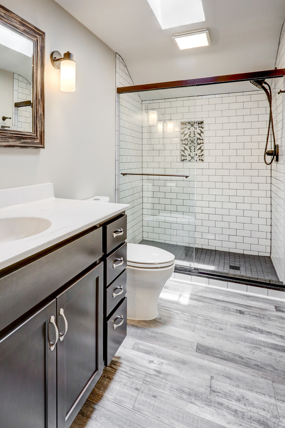 Lancaster Bathroom Remodel with gray floors and dark accents