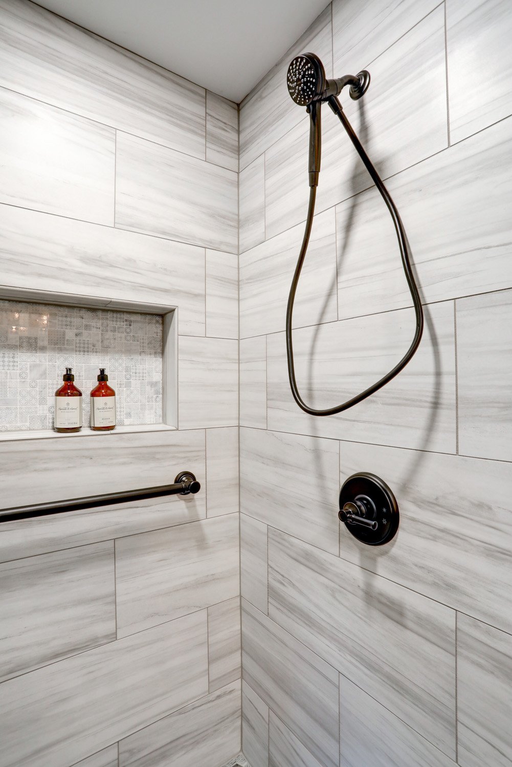 Matte black showerhead and grab bar in Manheim Township Bathroom