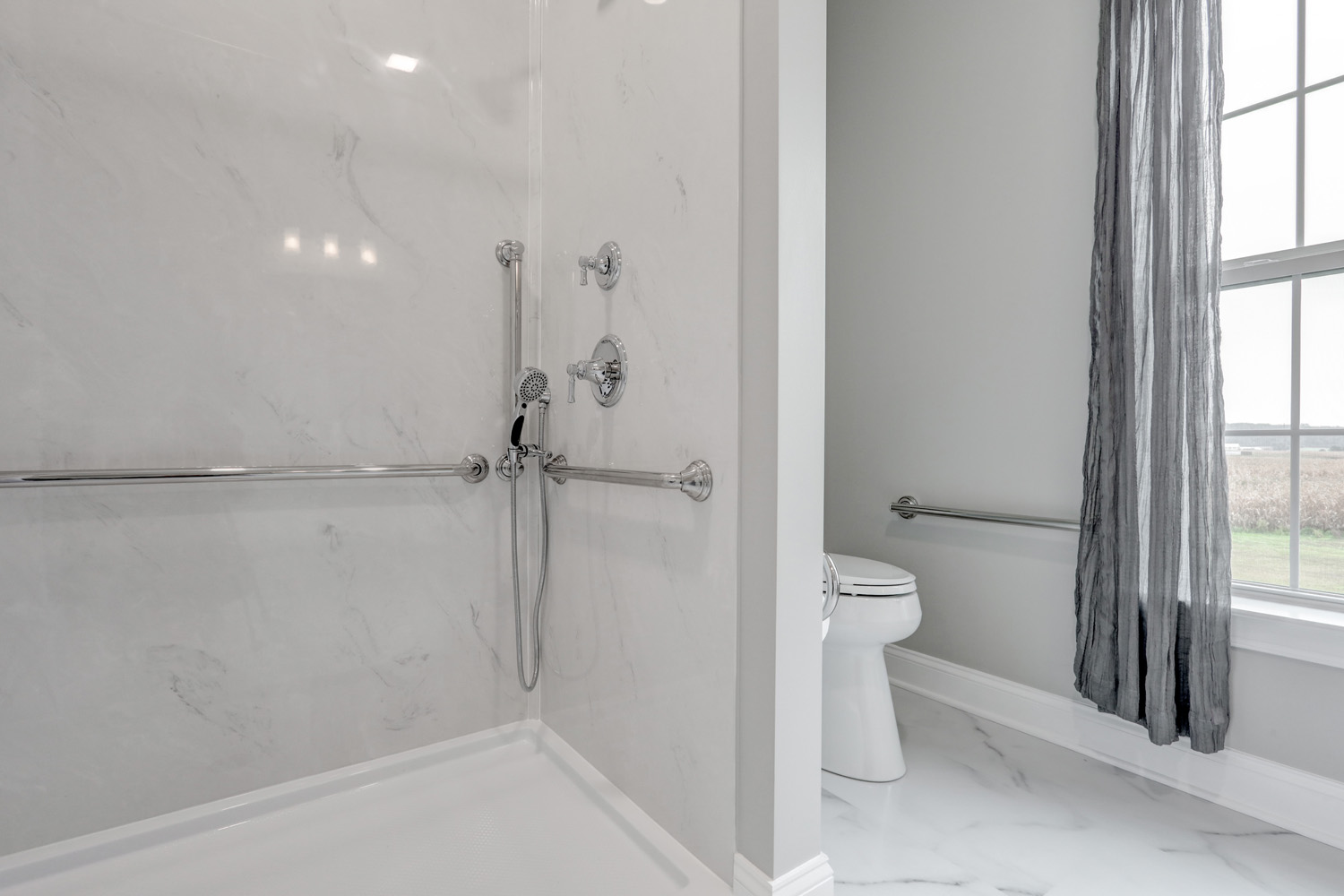 Shower with marble surround and grab bars in Lebanon bathroom