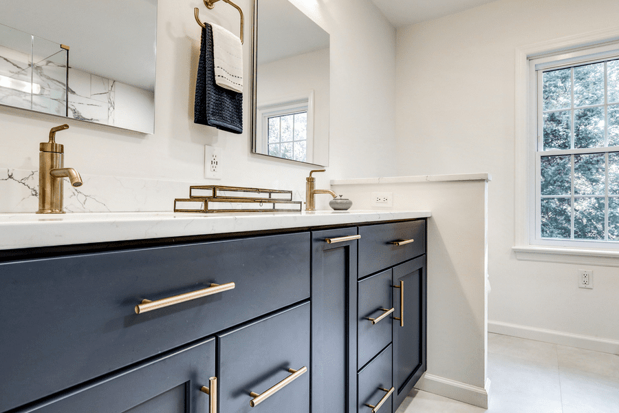 blue cabinets with gold pulls in Hempfield Master Bathroom Remodel 