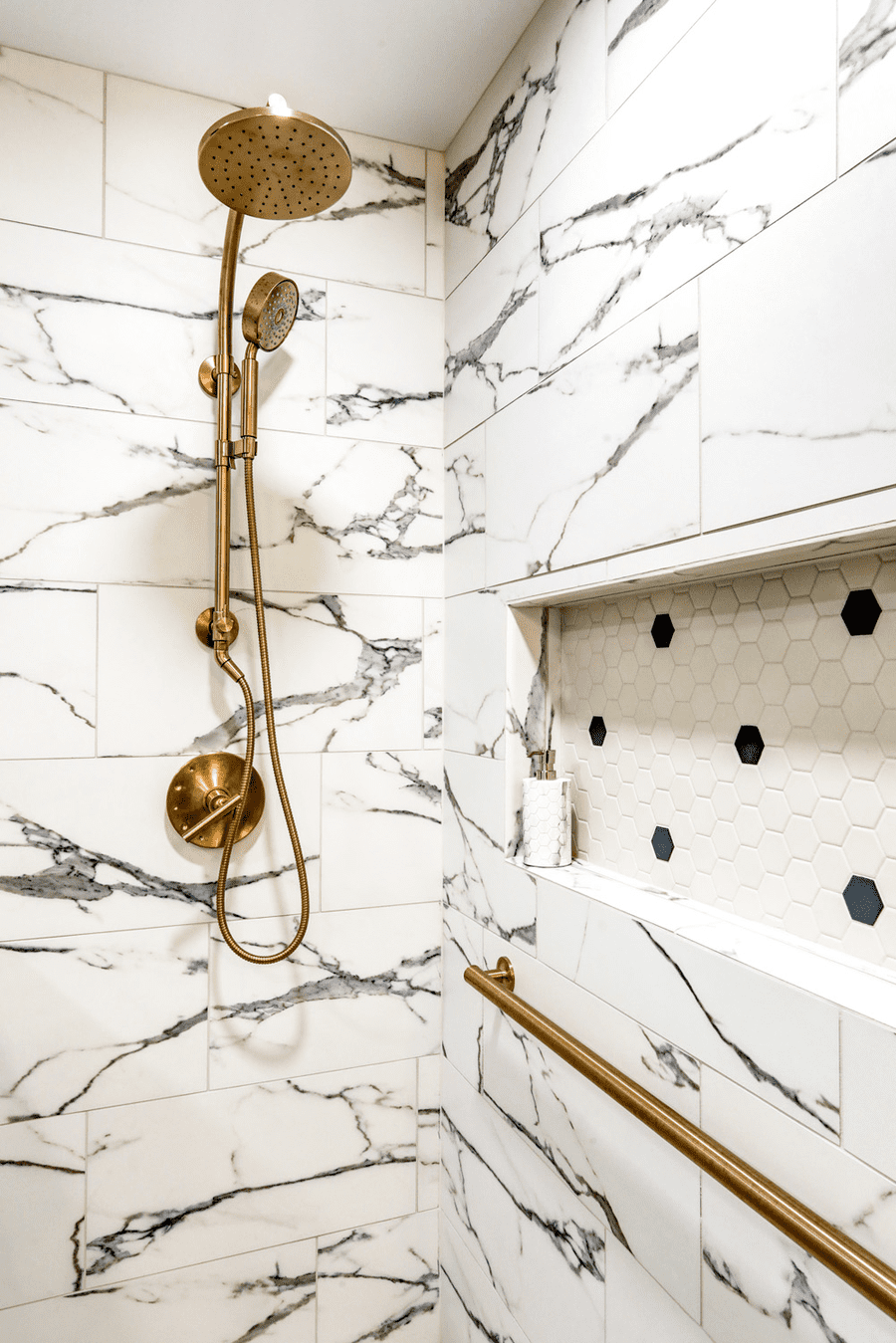 Tile shower with gold accents in Hempfield Master Bathroom Remodel 