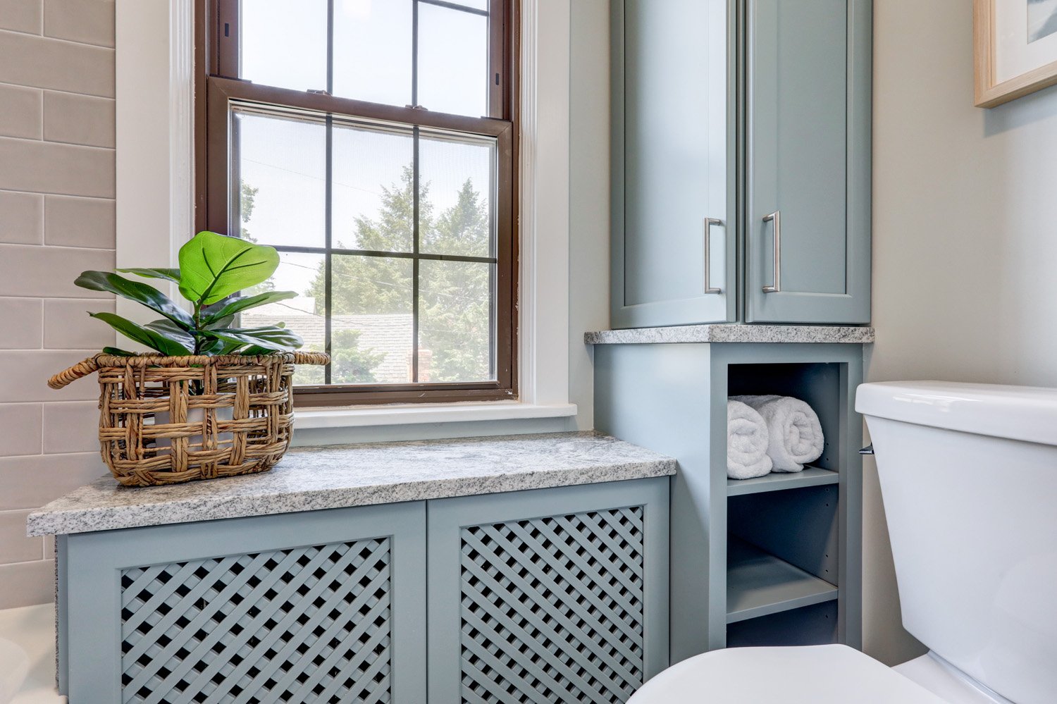 Blue cabinets and radiator cover in Lancaster Bathroom Remodel