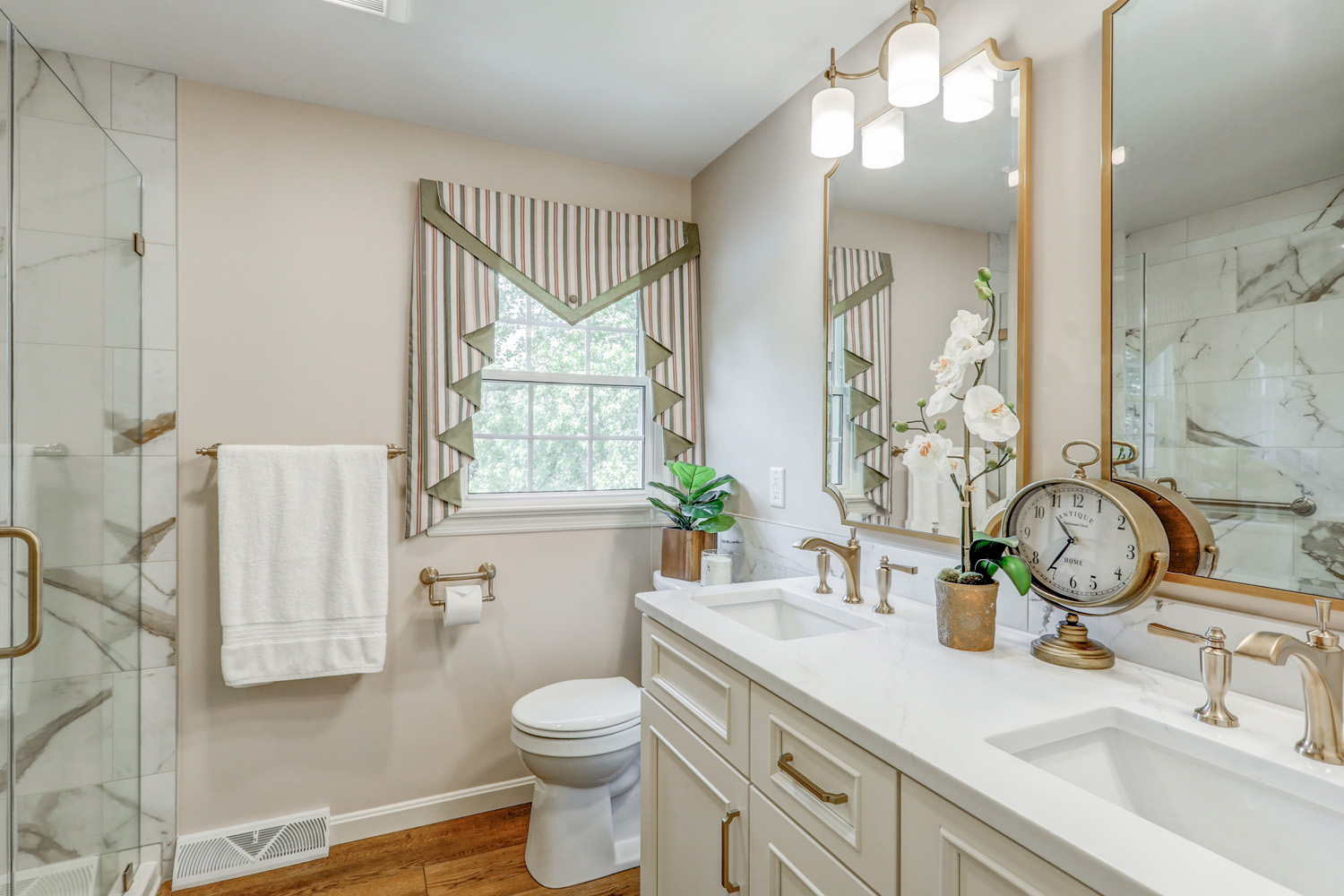 Classic bathroom remodel with champagne bronze fixtures