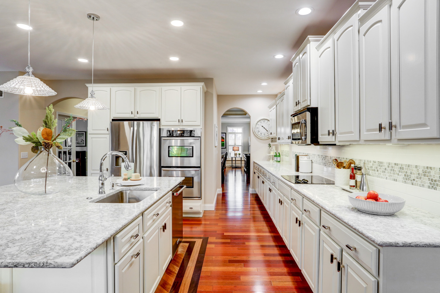 White kitchen with brown hardware floors in Centerville Kitchen Remodel