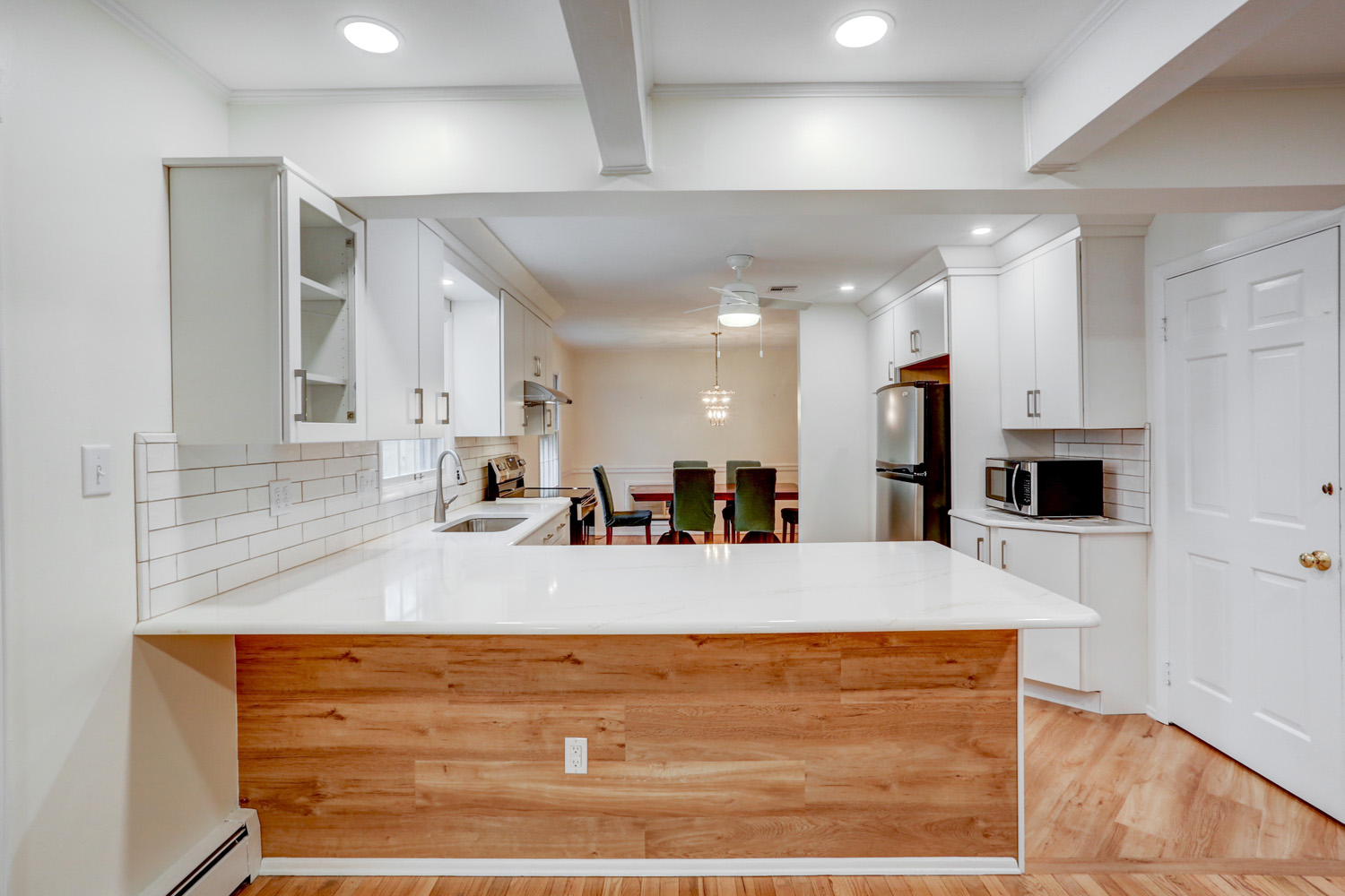 Kitchen remodel in Lancaster PA with white cabinets and wood accents