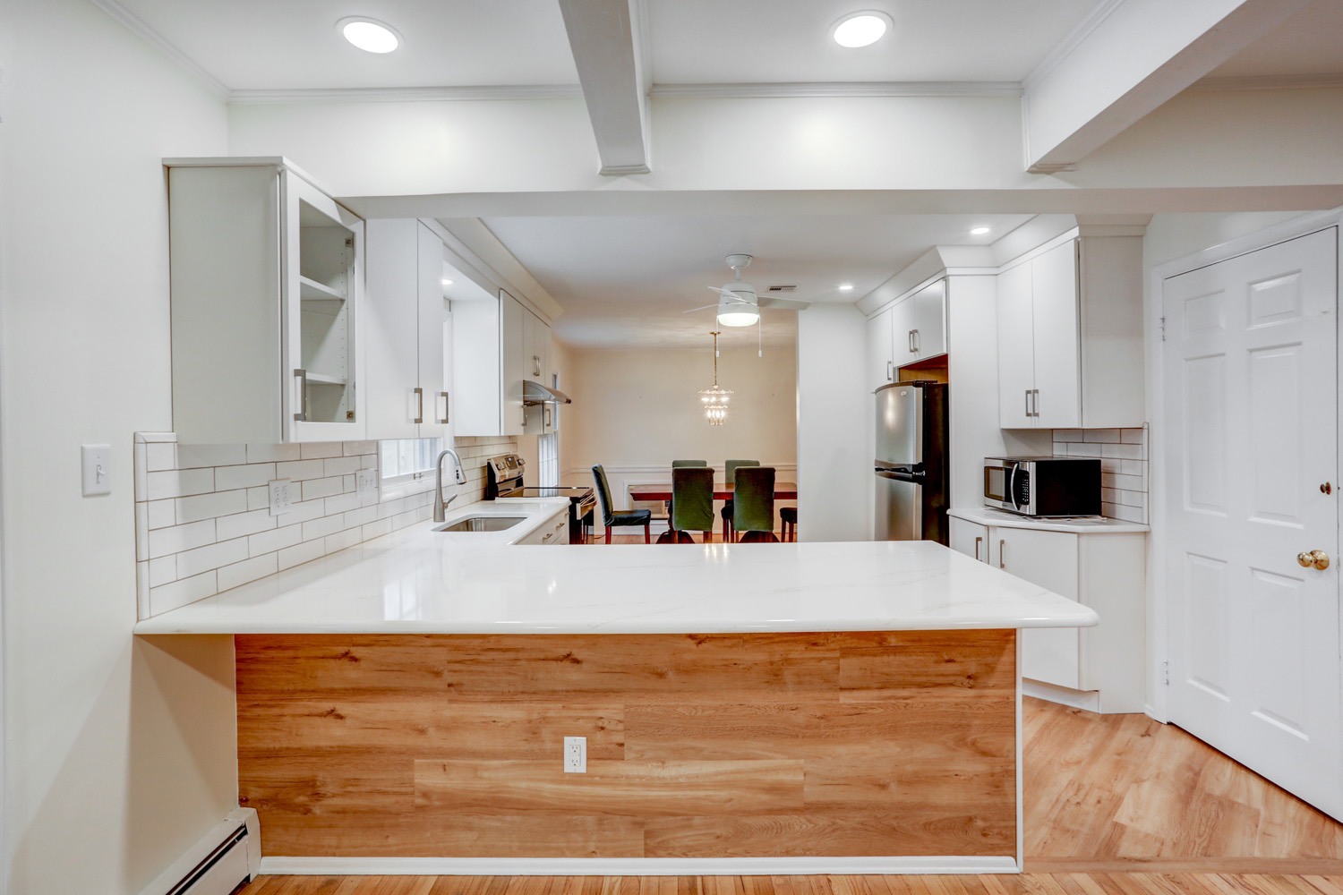 Kitchen remodel in Lancaster PA with white cabinets and wood accents