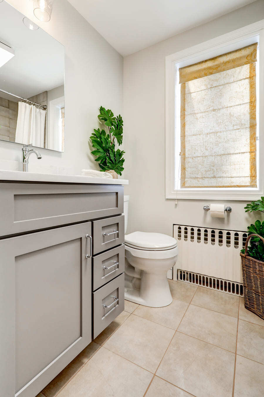 gray vanity with gold hardware in Lancaster primary bathroom remodel