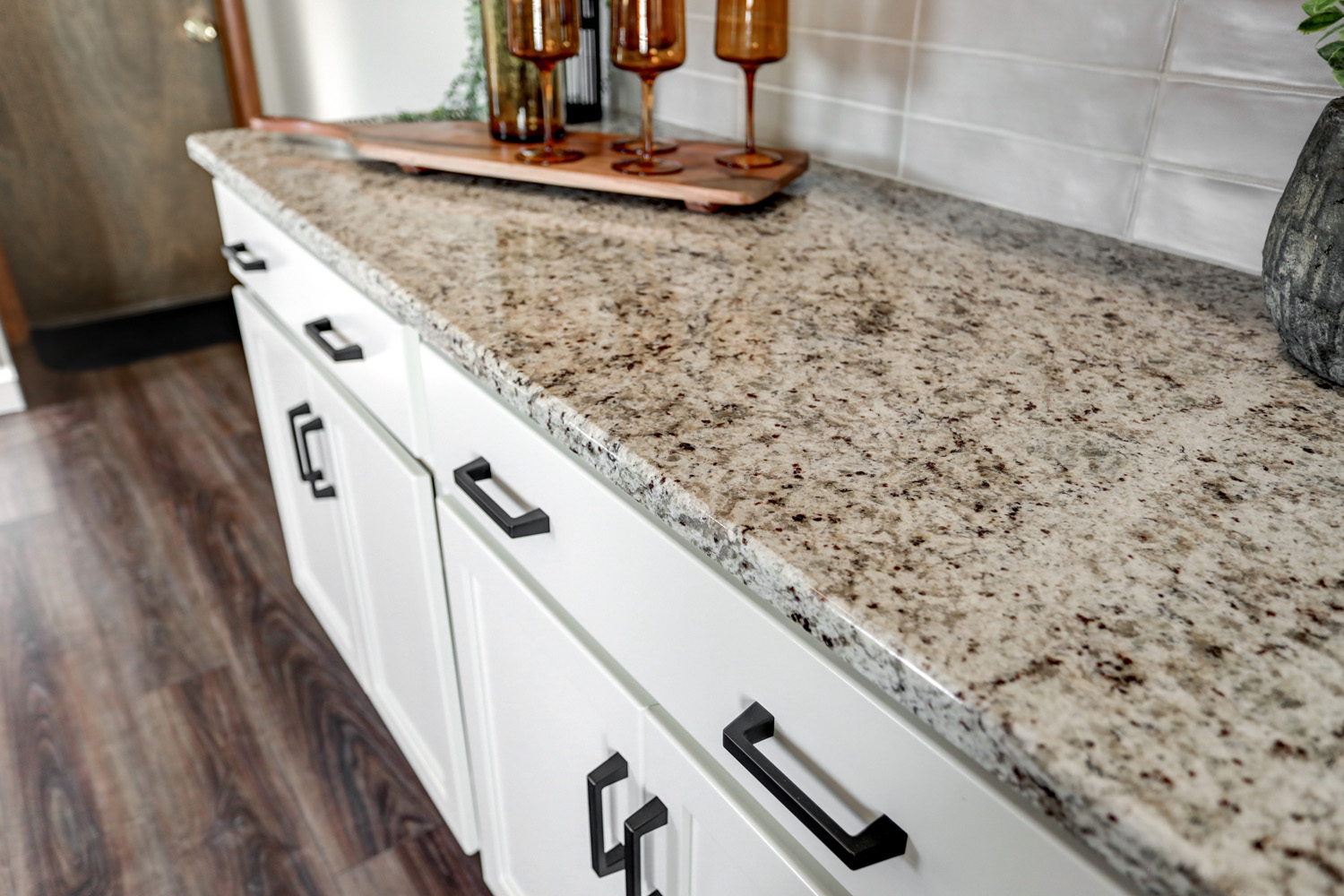 Granite counter top and matte black hardware in Paradise Kitchen Remodel