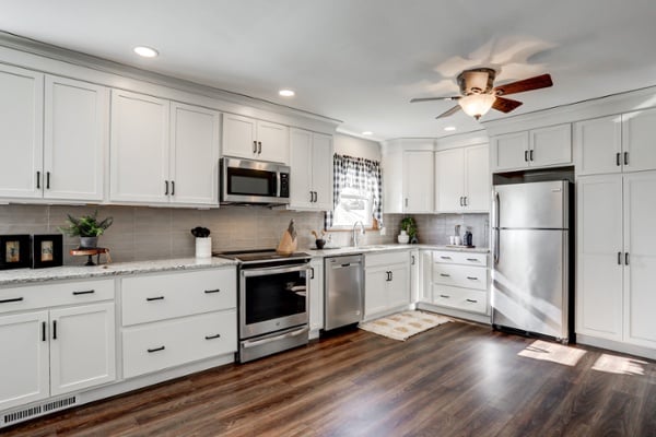 White cabinets and dark wood floors in Lancaster kitchen remodel