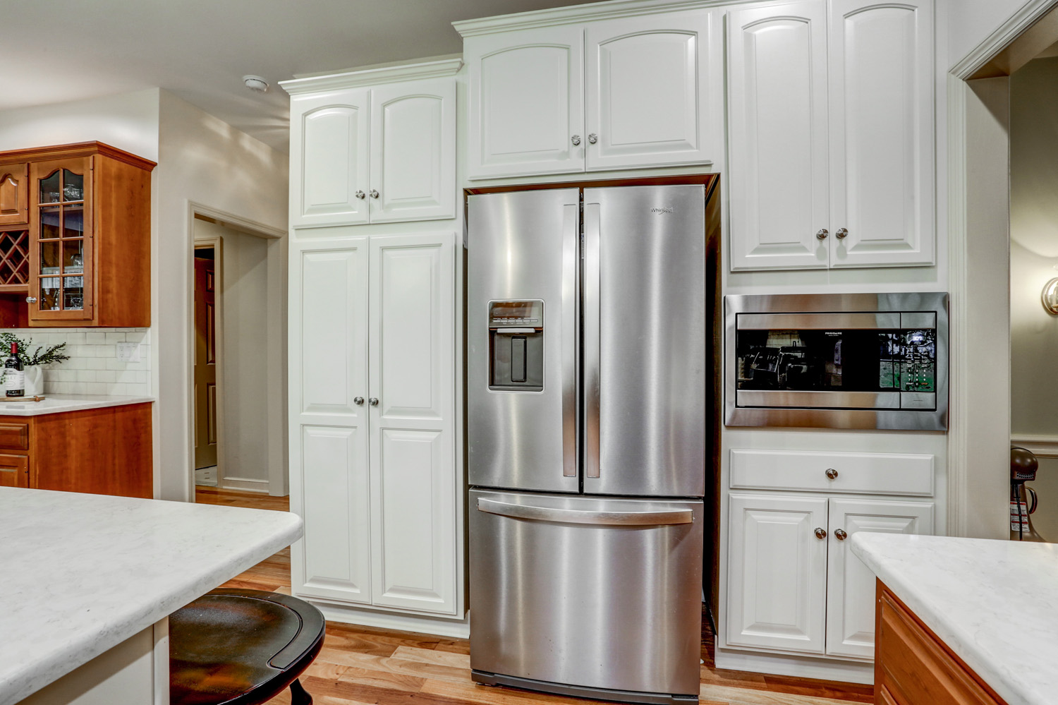 Centerville Kitchen Refresh with new white cabinets around refrigerator and microwave