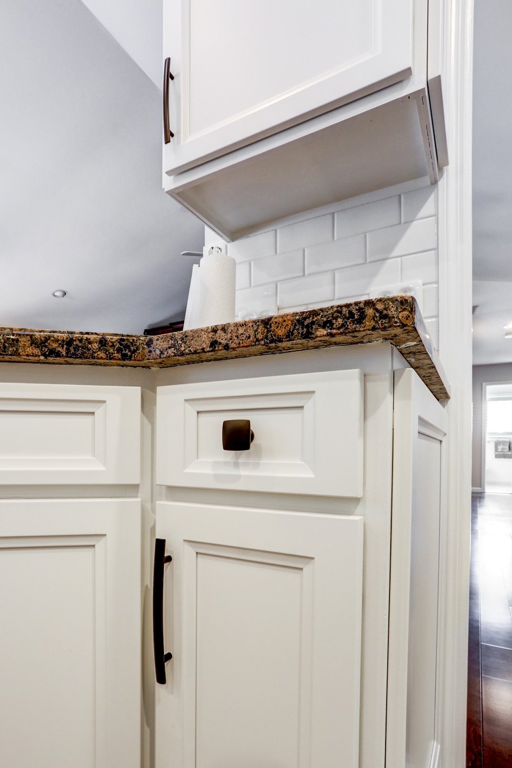 Updated white cabinets with bronze hardware in Manheim Central Kitchen Facelift