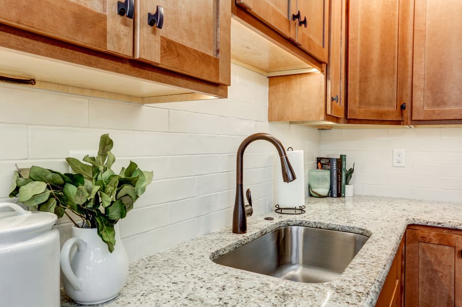 Hempfield Kitchen Remodel with granite countertops, white backsplash, and oil rubbed bronze faucet 