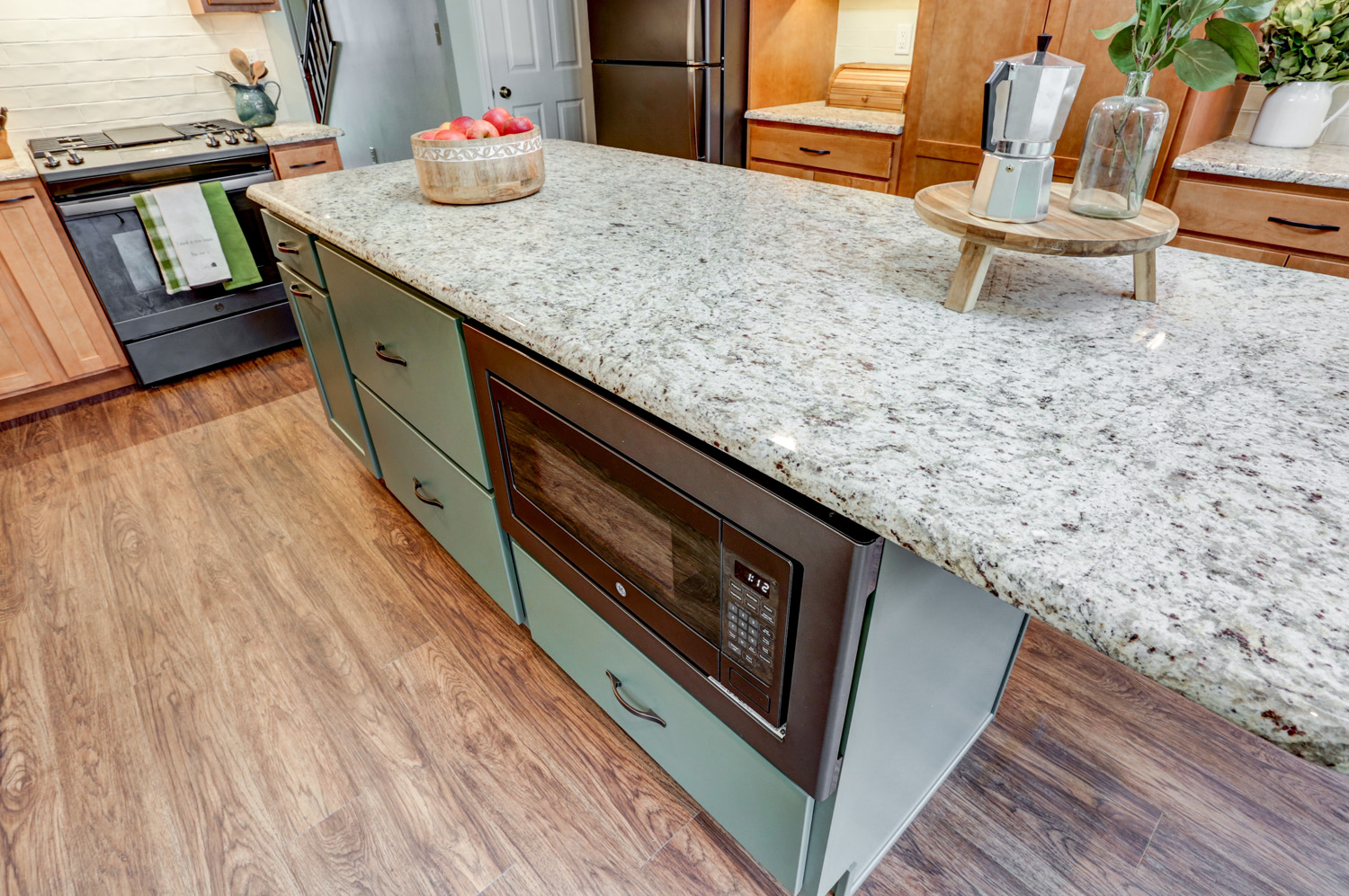 Island with granite countertop with microwave in Hempfield Kitchen Remodel