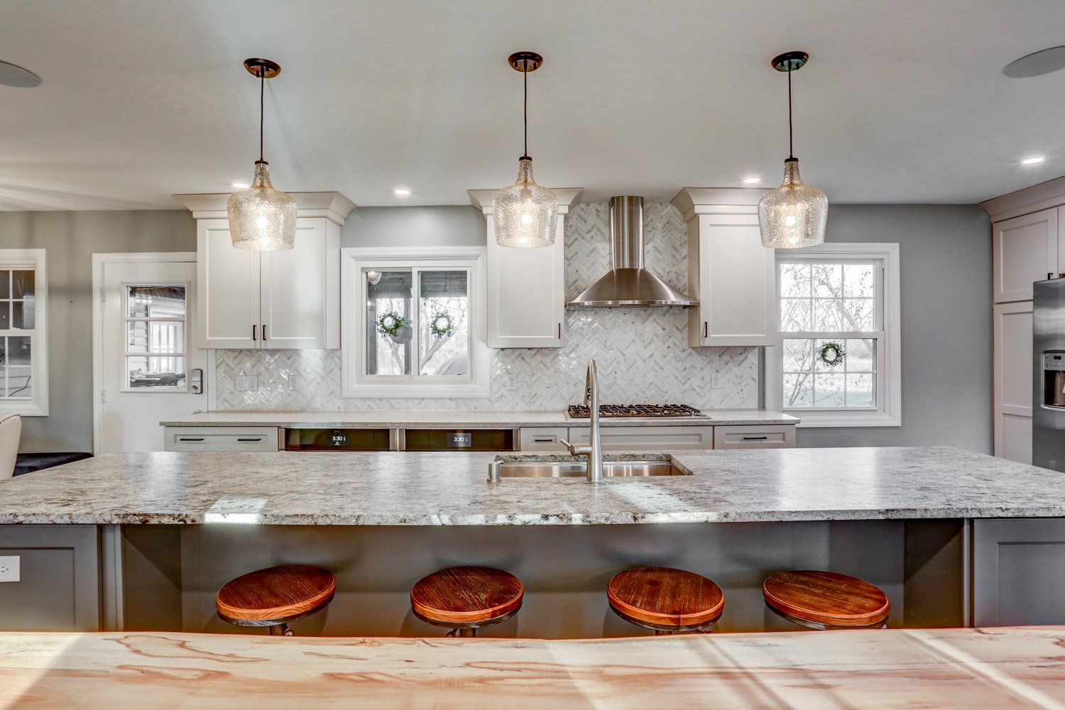 Island bar top with industrial stool in Lancaster kitchen remodel